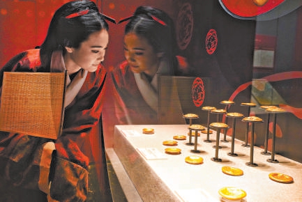 參觀預展的游客身着漢服觀賞黃金器物,其中涵蓋褭蹏金(馬蹄金)、麟趾金、金餅等完整品類,純度高達99%。 參觀預展的游客身着漢服觀賞黃金器物,其中涵蓋褭蹏金(馬蹄金)、麟趾金、金餅等完整品類,純度高達99%。