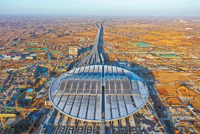 作为京津冀协同发展的重大工程之一,2020年12月27日京雄城际列车正式开通。高空俯瞰京雄城际终点站雄安站,椭圆形的站房雄伟大气,高铁轨道从站房延伸而出,直达远方地平线外。.jpg 作为京津冀协同发展的重大工程之一,2020年12月27日京雄城际列车正式开通。高空俯瞰京雄城际终点站雄安站,椭圆形的站房雄伟大气,高铁轨道从站房延伸而出,直达远方地平线外。.jpg