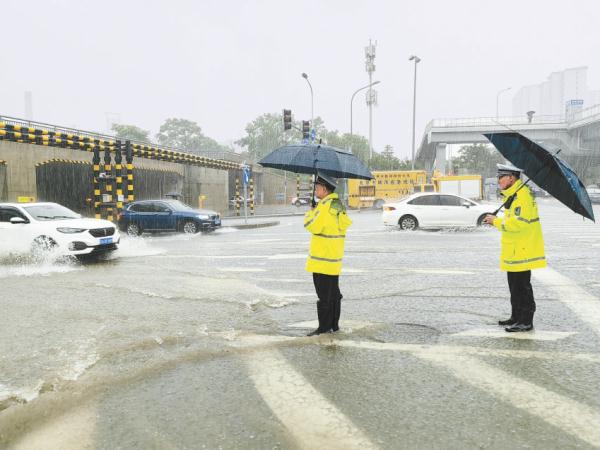 7月31日，石景山区金安桥铁路桥下出现积水，交警指挥交通，排水集团工作人员进行抽排。为保障过往车辆和行人安全，采取双向断路措施。