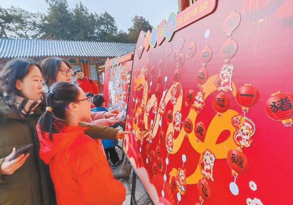 图为游客在颐和园参与成语接龙活动。