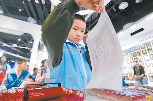 在北京科学中心，小朋友全神贯注体验拓印。