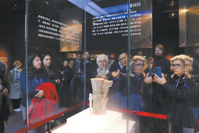 中外嘉宾仔细观赏每一件展品，品味中华文明。