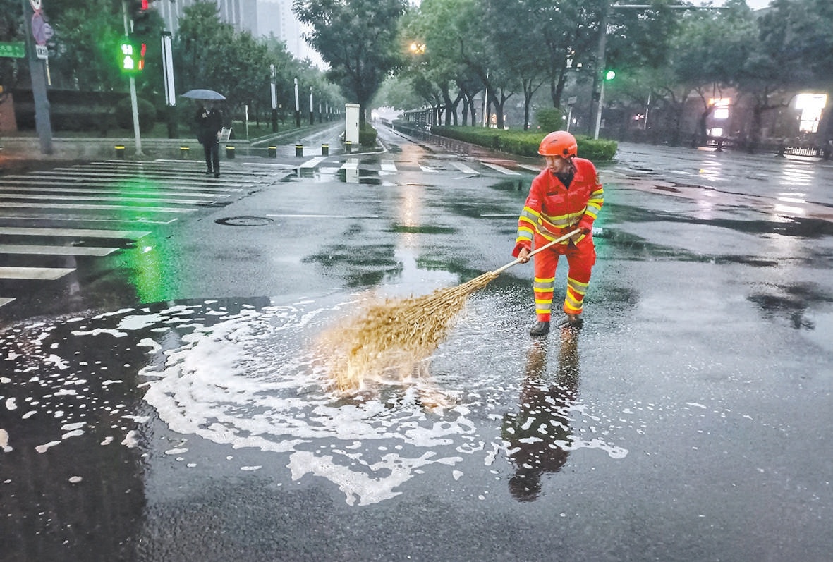 5月17日早,西城环卫职工对辖区内路口路段进行人工推水作业。 5月17日早,西城环卫职工对辖区内路口路段进行人工推水作业。