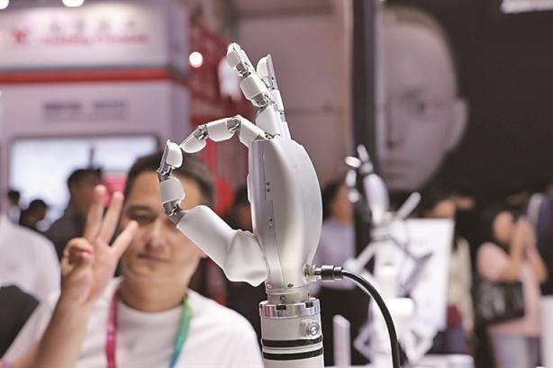 观众在2025世界机器人大会上观看一款灵巧手。 观众在2025世界机器人大会上观看一款灵巧手。