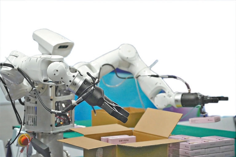 Robot arms handling product packaging during an industrial scenario task