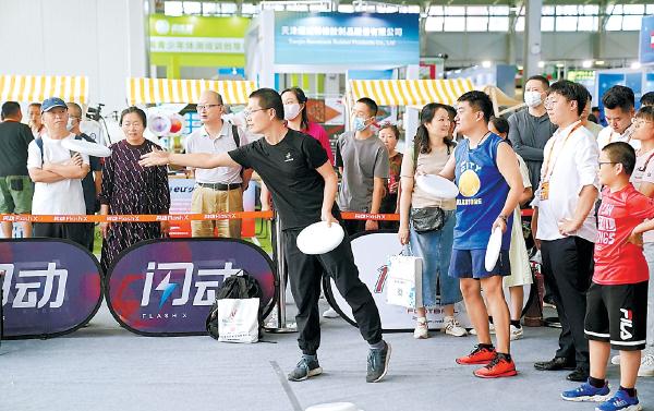 在體育服務展區，淺波沖浪、飛盤、專業冰壺等多項體育運動吸引了參觀者排隊體驗。
