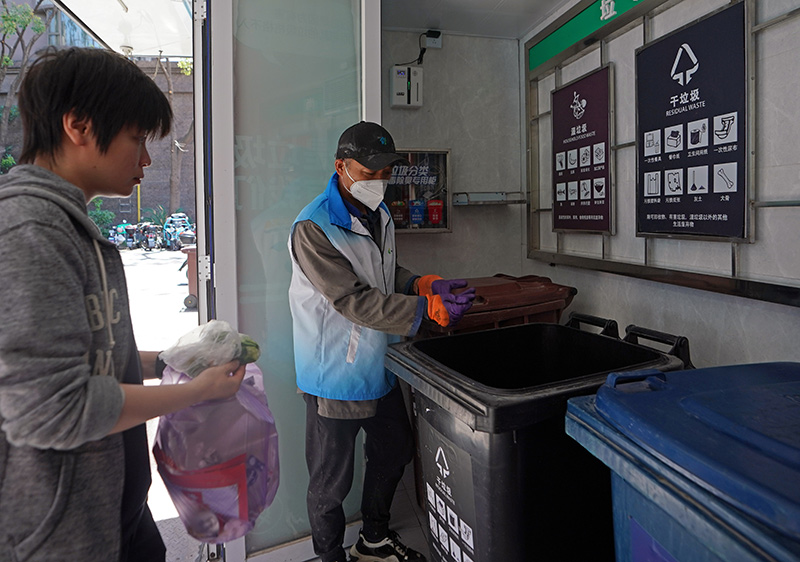 在上海市虹口區嘉興路街道愛家豪庭小區，垃圾分類志願者在投放時間段內服務（2023年5月23日攝）。