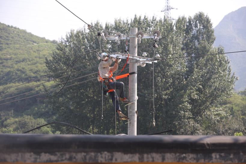 國網北京房山供電公司在災後重建現場建設線路。