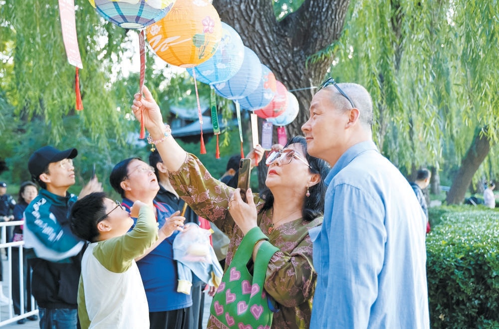 玉淵潭公園開啟中秋文化體驗之旅，游客在園內猜燈謎、做花燈。