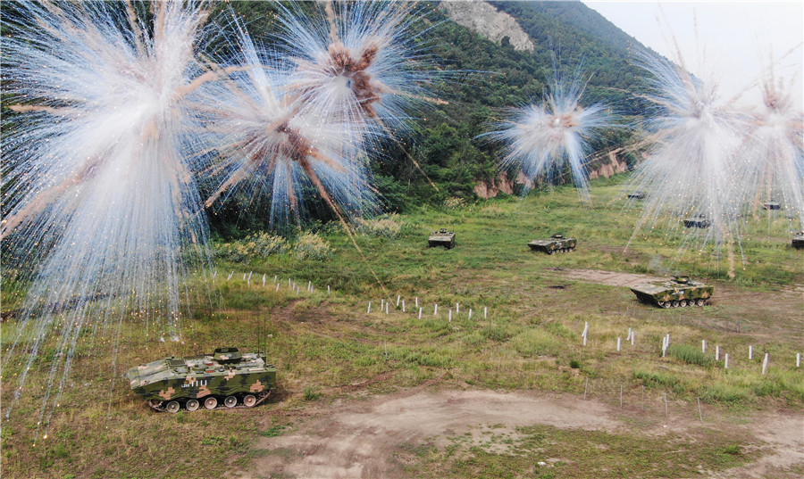 對抗演練中，陸軍第83集團軍某旅“紅一連”某型步戰車利用煙幕掩護，向“敵”陣地發起衝擊