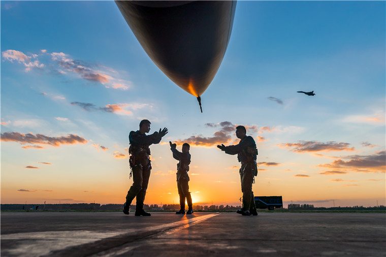 即將升空進行二對一自由空戰訓練的北部戰區空軍航空兵某旅飛行員在戰機前演練