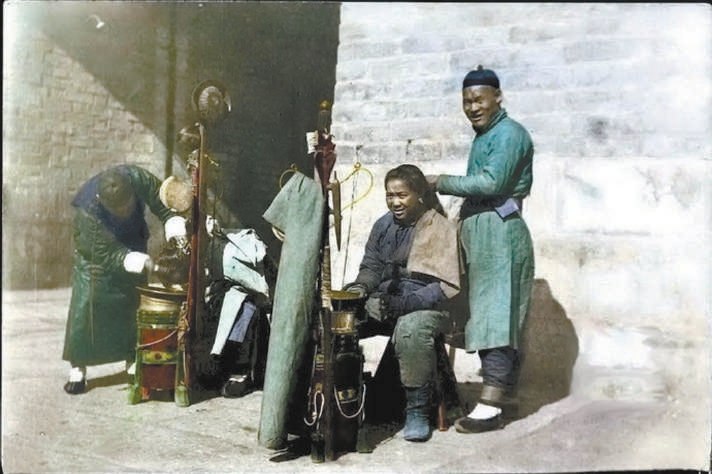 1900年代，人们在城门洞边上剃头、打辫子。