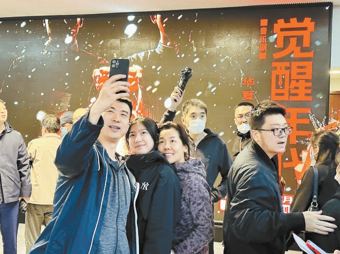 观众在《觉醒年代》海报前打卡留念。
