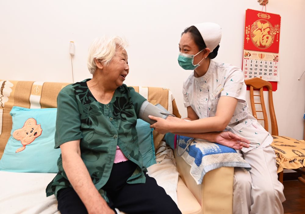 河北廊坊三河市燕达金色年华健康养护中心医务人员为入住老人测量血压（2023年7月20日摄）。