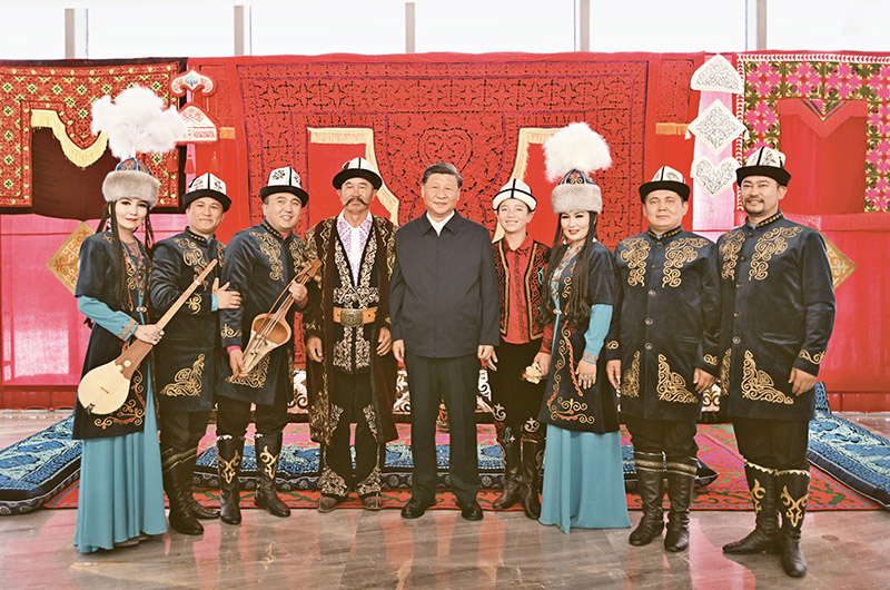 2022年7月12日至15日，中共中央总书记、国家主席、中央军委主席习近平在新疆考察。这是13日上午，习近平在乌鲁木齐市新疆维吾尔自治区博物馆，同《玛纳斯》非物质文化遗产传承人在一起。