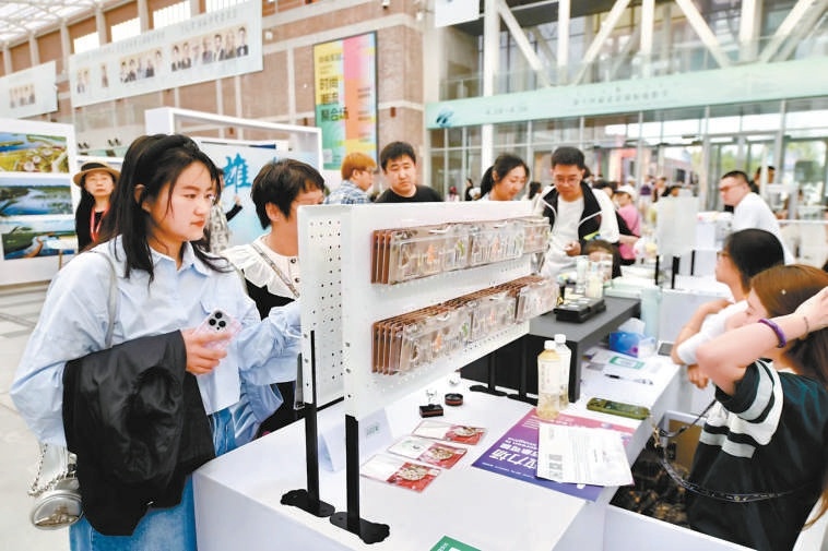 观众正在选购北影节官方文创产品。