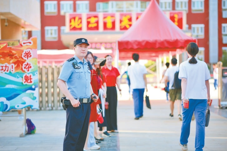6月24日，在育英中学外，民警进行巡逻保障。