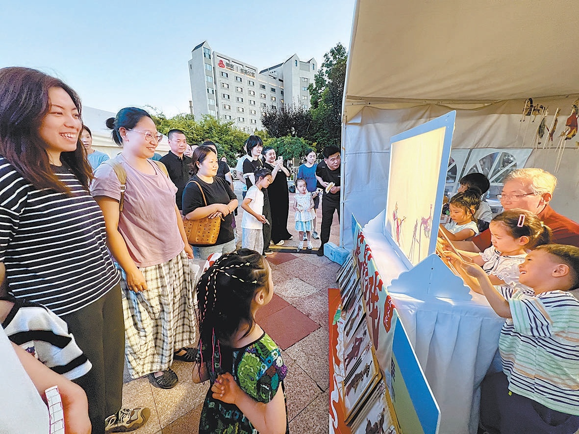 7月6日，一处皮影戏摊位人气颇旺，吸引众多消费者围观体验。