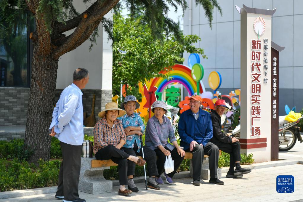 山东省沂源县南麻街道埠下村村民在民生综合体活动广场休息（2022年6月15日摄）。（朱峥 摄）