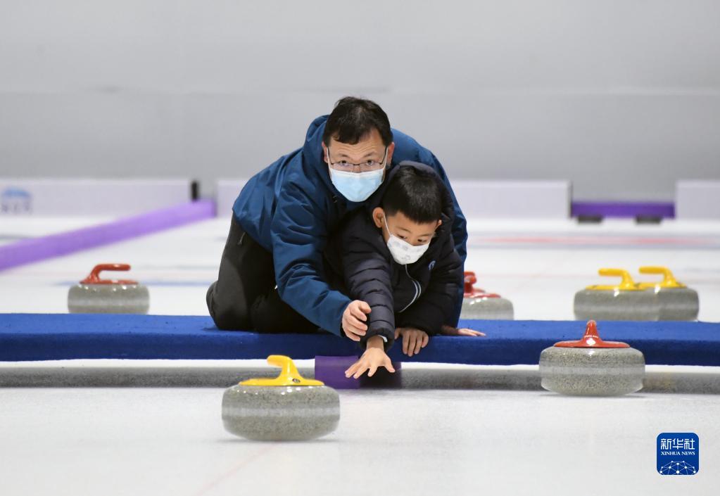 2023年1月23日，游客在“冰立方”冰上运动中心体验冰壶运动。
