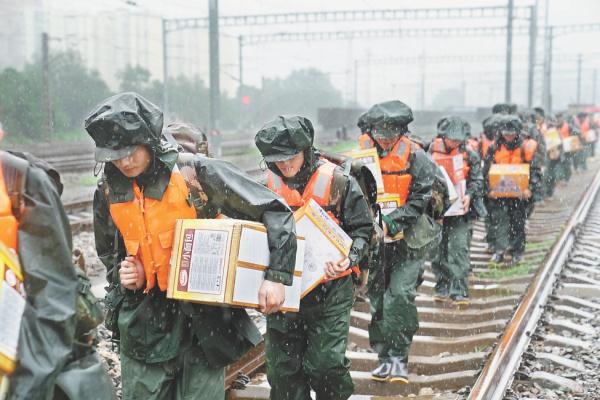 8月1日，武警战士携带物资冒着风雨向妙峰山镇水峪嘴村徒步行进，援救被困、受伤群众。