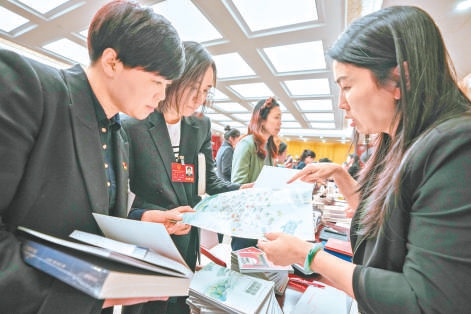 1月24日晚上,市人大代表询问、政协委员咨询活动在北京会议中心举行。在市文化和旅游局咨询台,工作人员在向杜岩代表(左)、魏雪代表(中)介绍旅游休闲绿道建设。 1月24日晚上,市人大代表询问、政协委员咨询活动在北京会议中心举行。在市文化和旅游局咨询台,工作人员在向杜岩代表(左)、魏雪代表(中)介绍旅游休闲绿道建设。